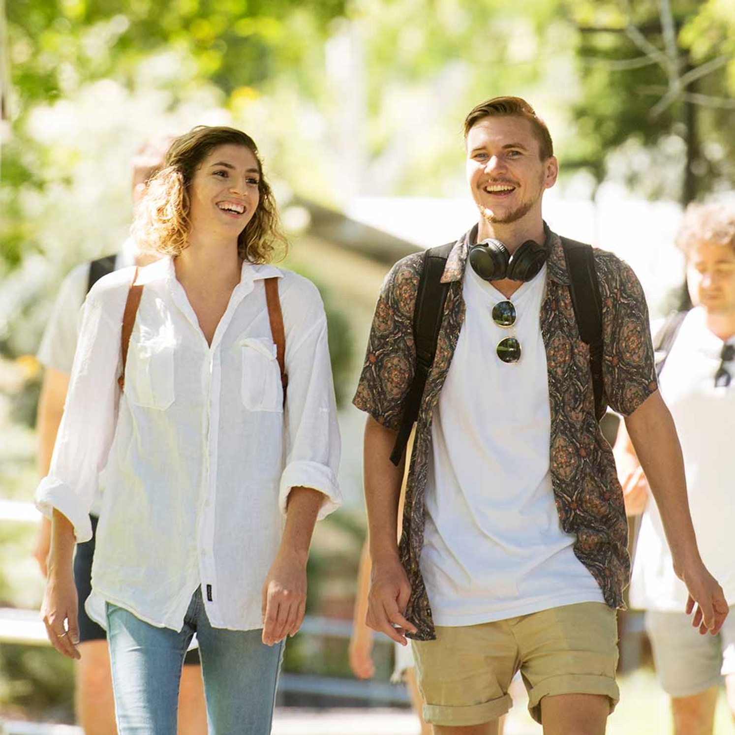 Female and male student walking and smiling together