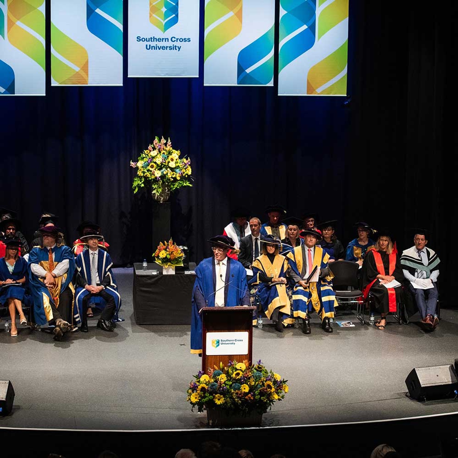 the vice chancellor and academic leaders on stage at a southern cross University graduation ceremony