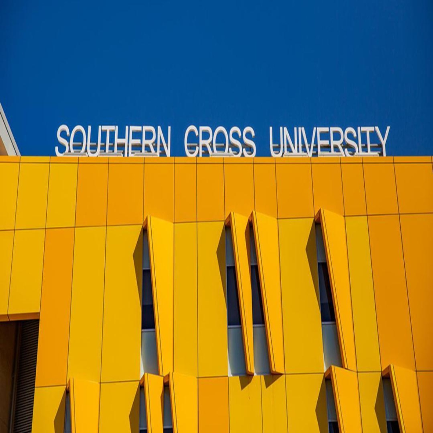 a details of a building on the gold coast campus, there is a sign hat says southern cross univerity