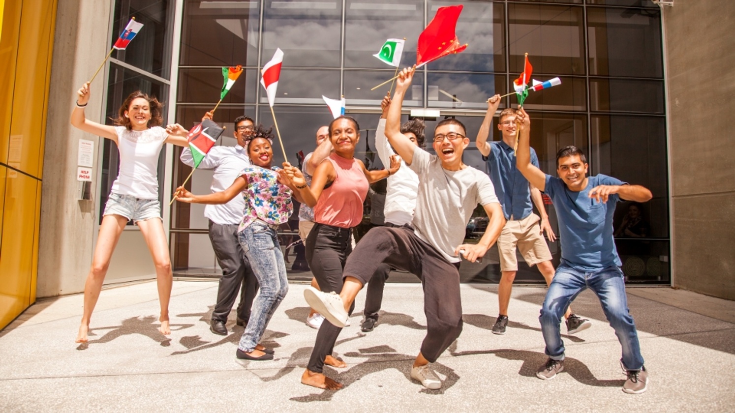 Students dancing with international flags