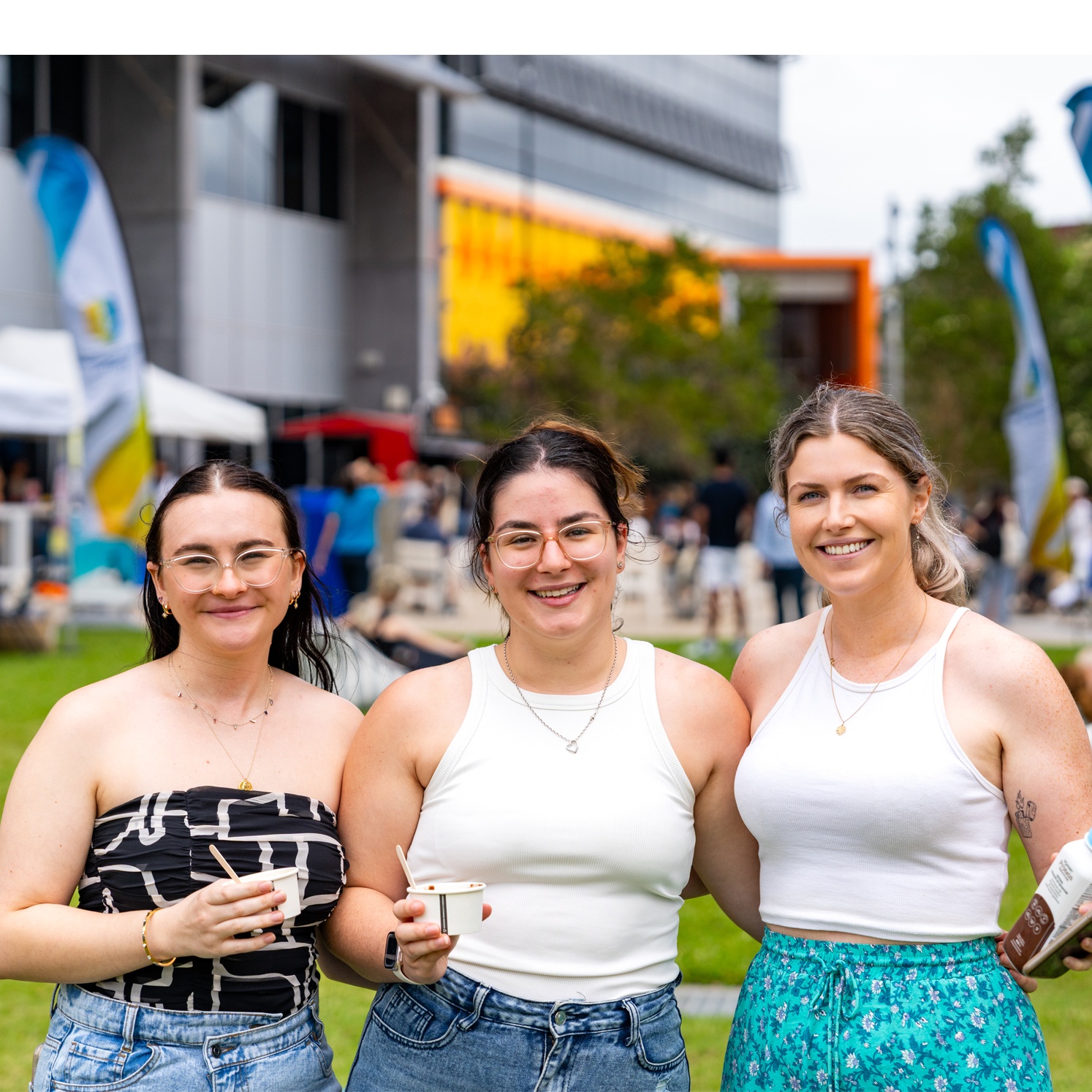 3 students standing looking at camera