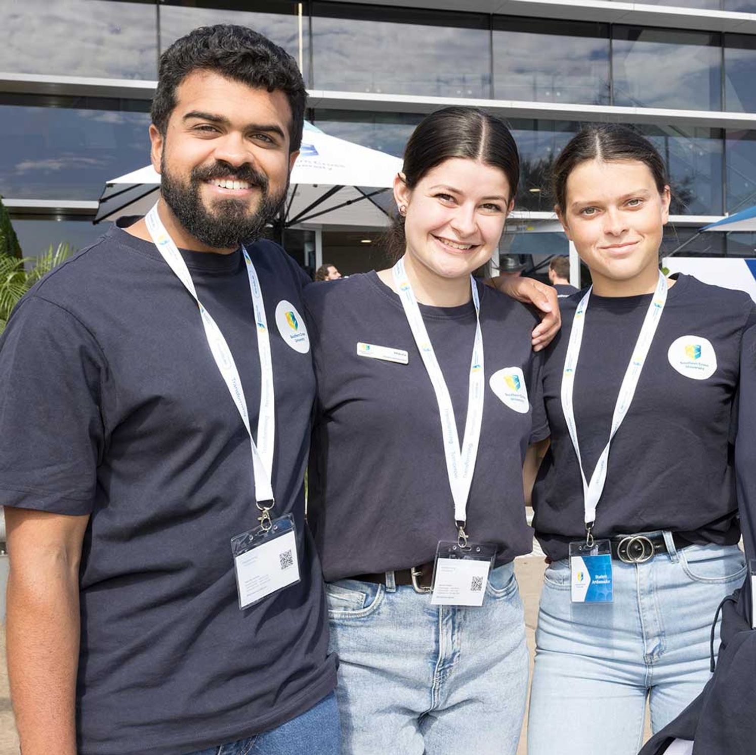3 students smiling at camera