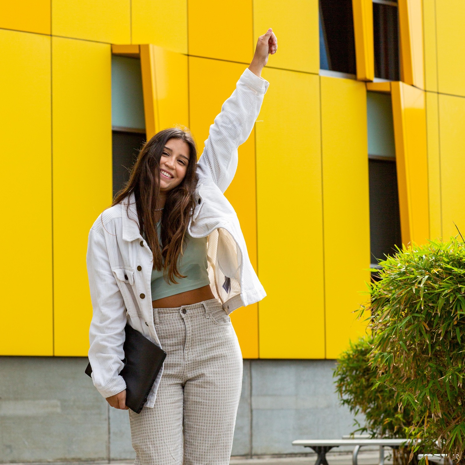 Student standing happy arm in the air