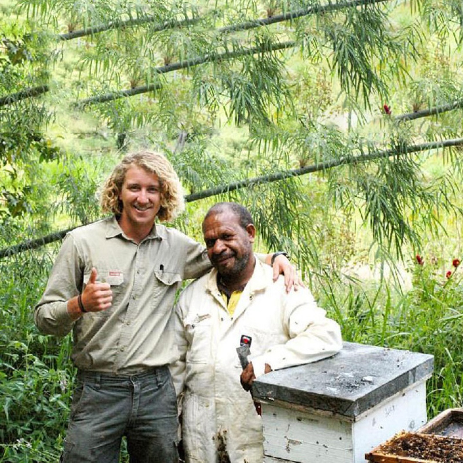 Cooper Schouten with a colleague and a beehive