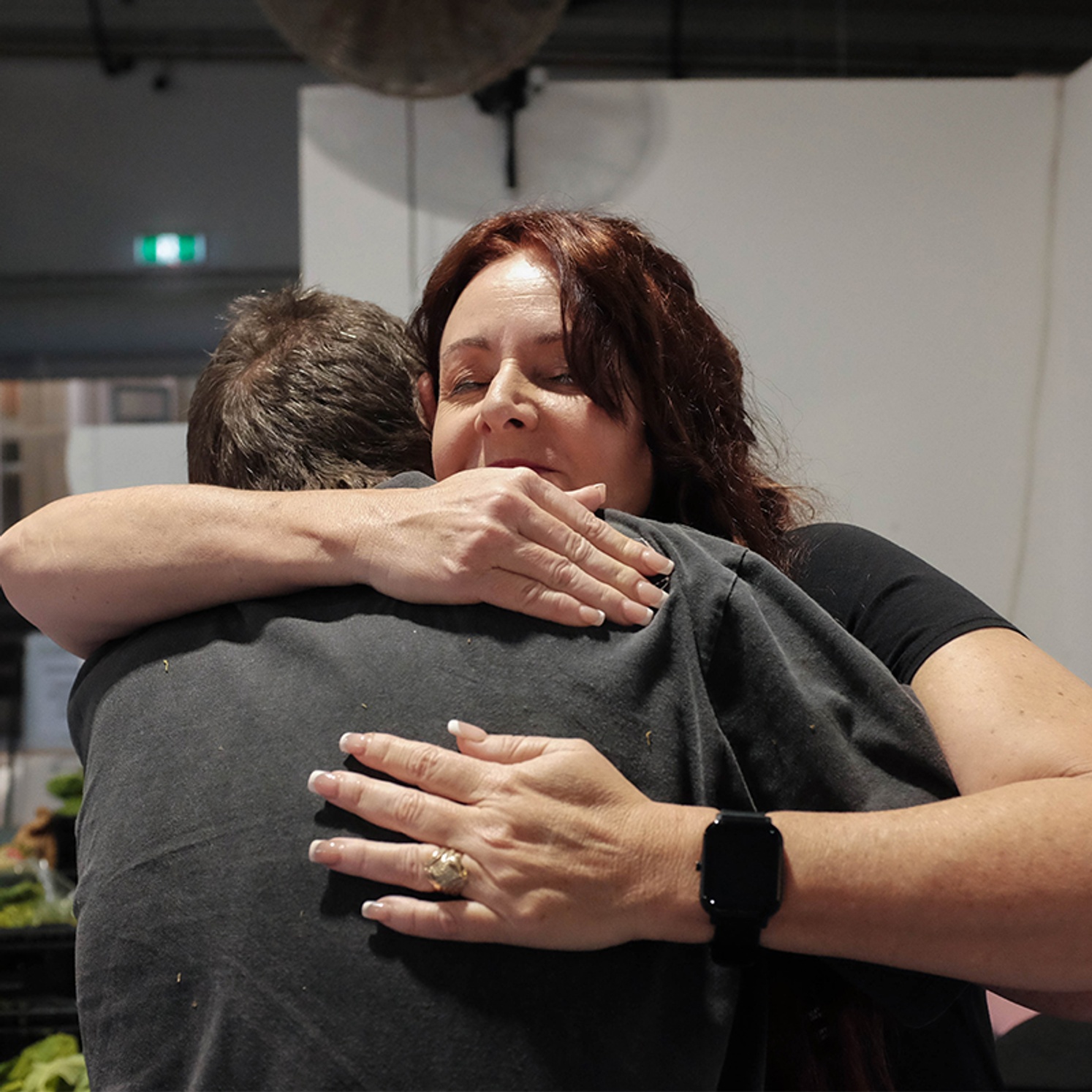 Theresa Mitchell giving community member a hug