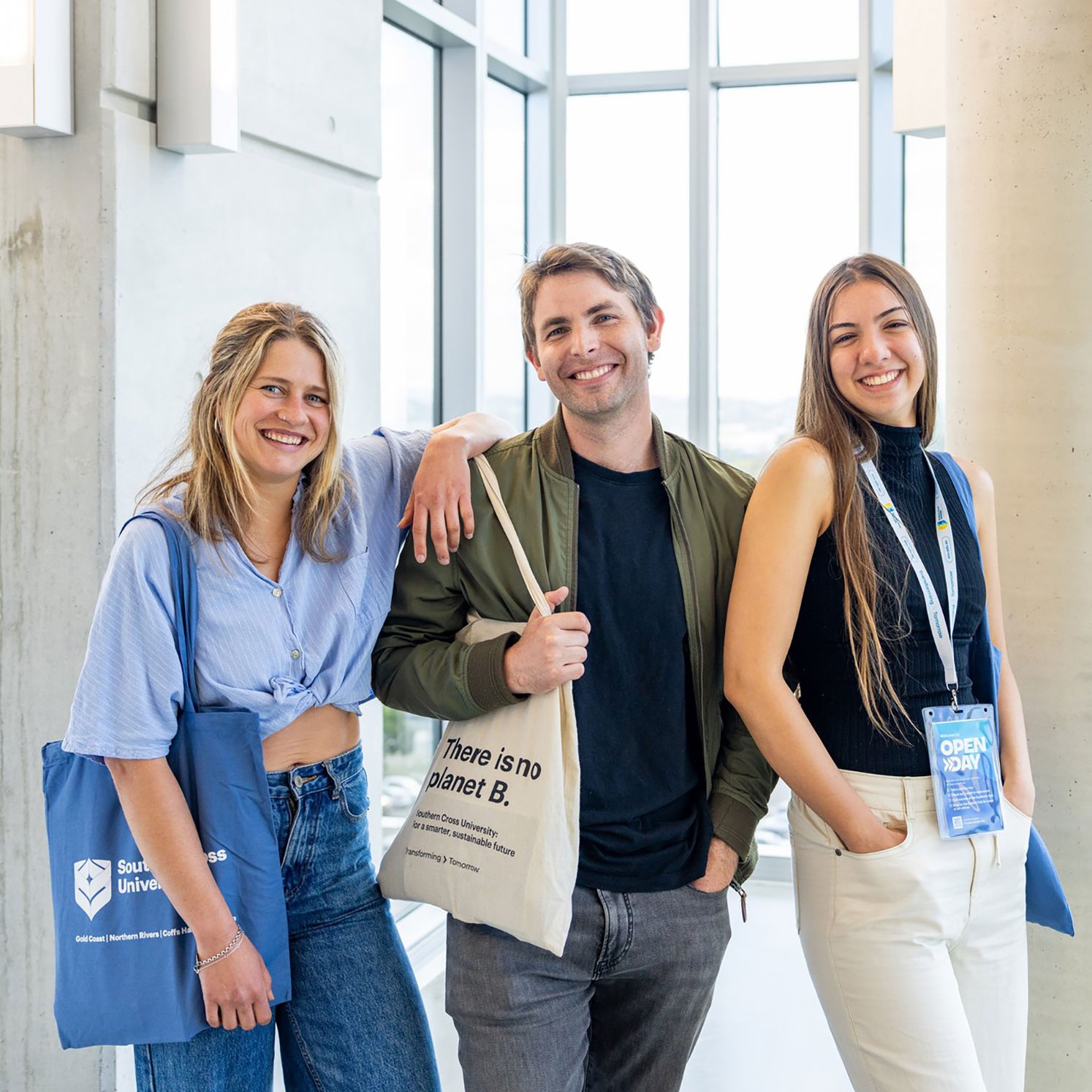 Three students smiling for a photo