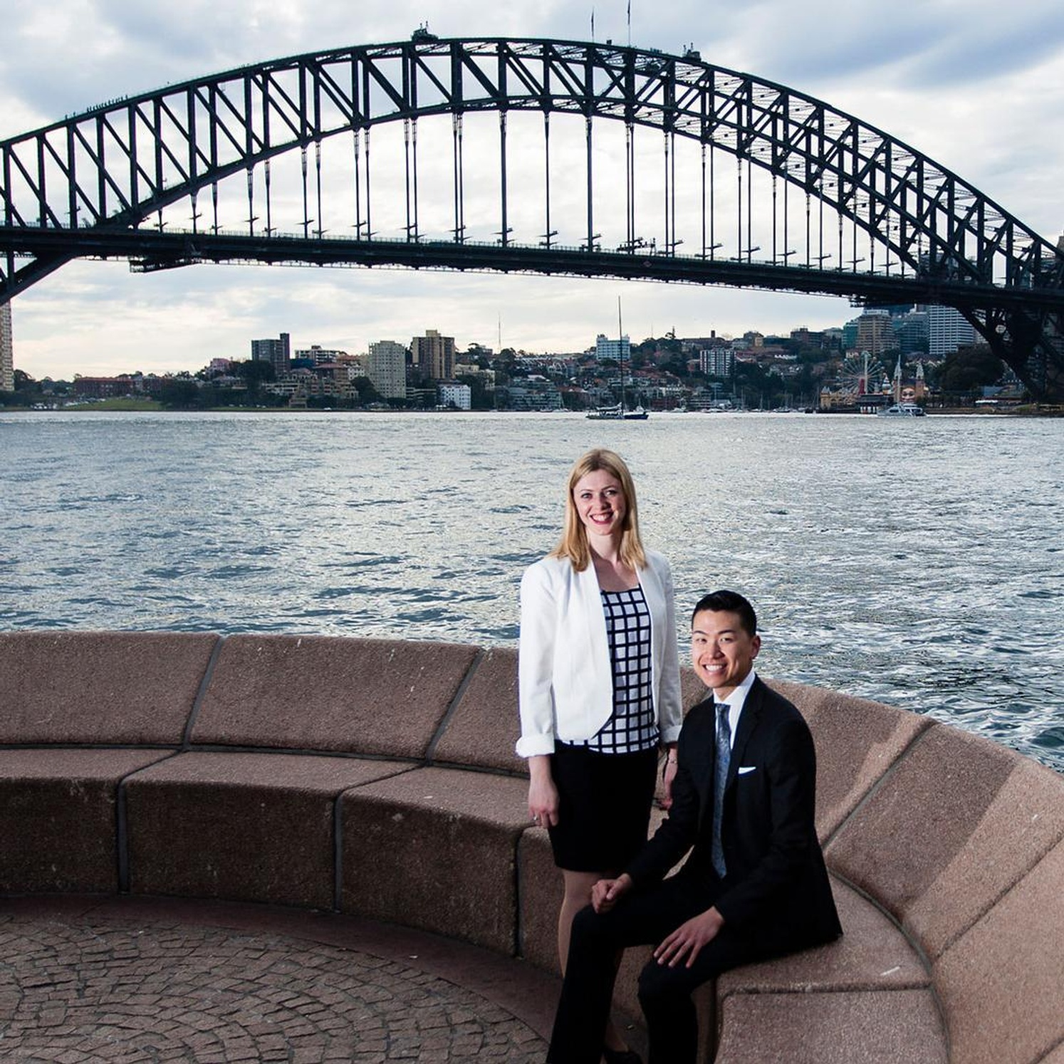 Two Southern Cross University students in front of the Sydney harbour 