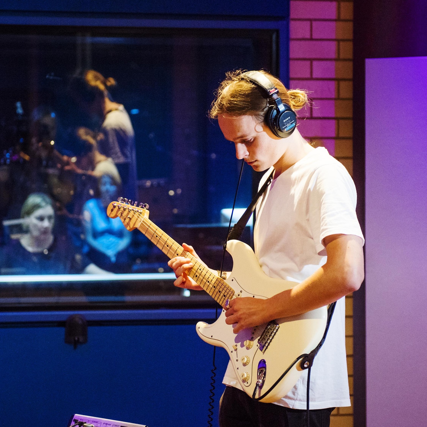 student playing guitar in recording Studio