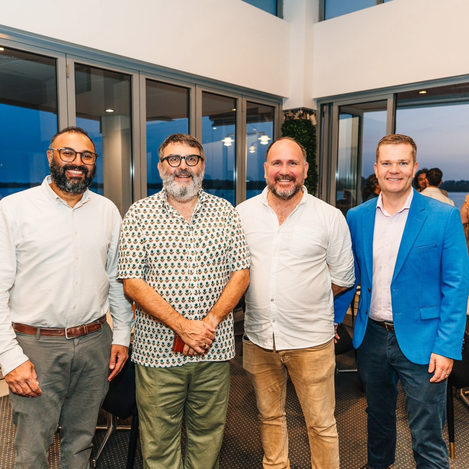 Four men smiling at the camera