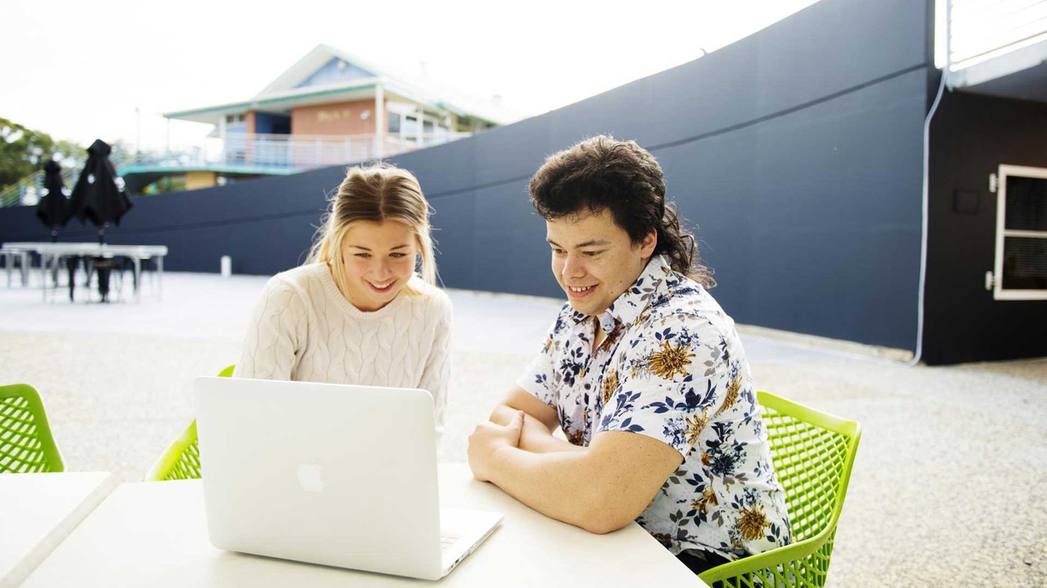 Female and male students with laptop at Coffs Harbour campus