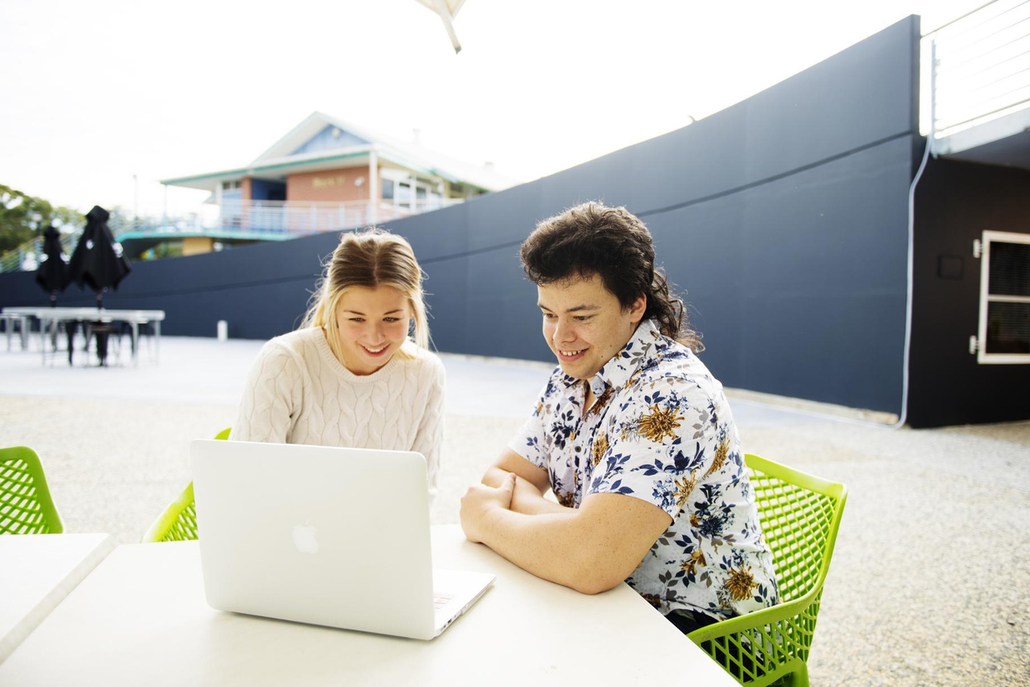 Female and male students with laptop at Coffs Harbour campus