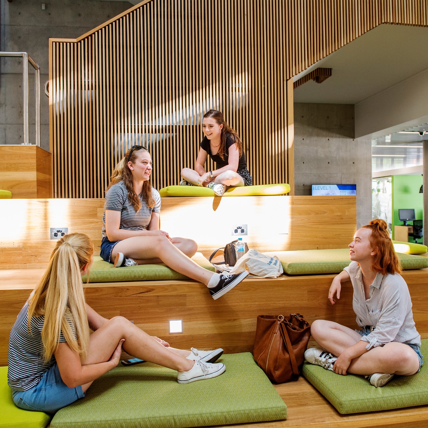 Students sitting on tiered seating in Lismore campus library