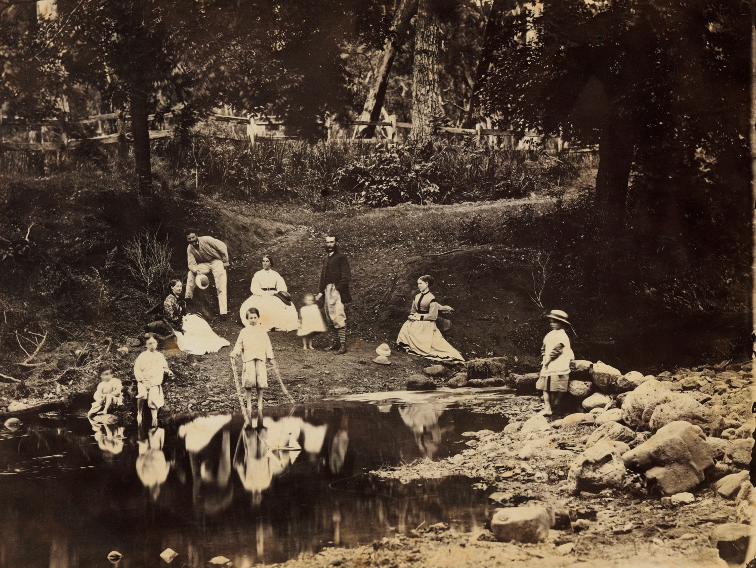 Historical image of the Sherwood family on the banks of the river