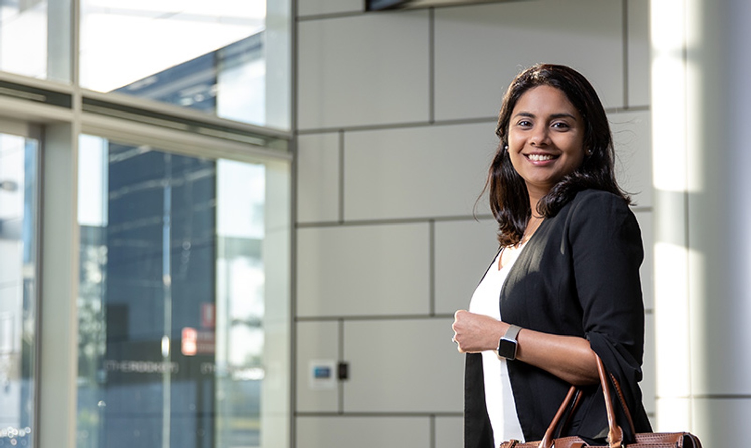 Ishitah Shah, Master of Professional  Accounting graduate.walking into an office building