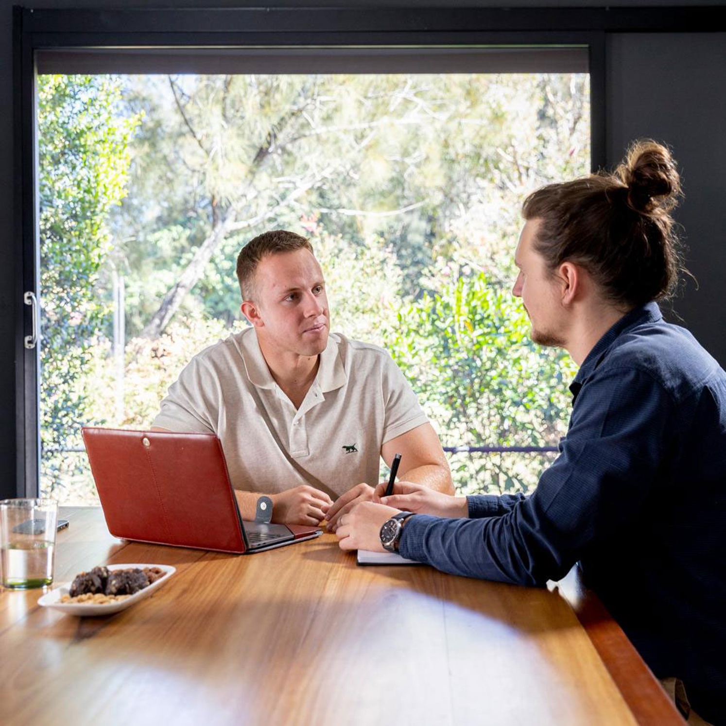 Business - Law student Isaac Hawkins sitting at table talking at work