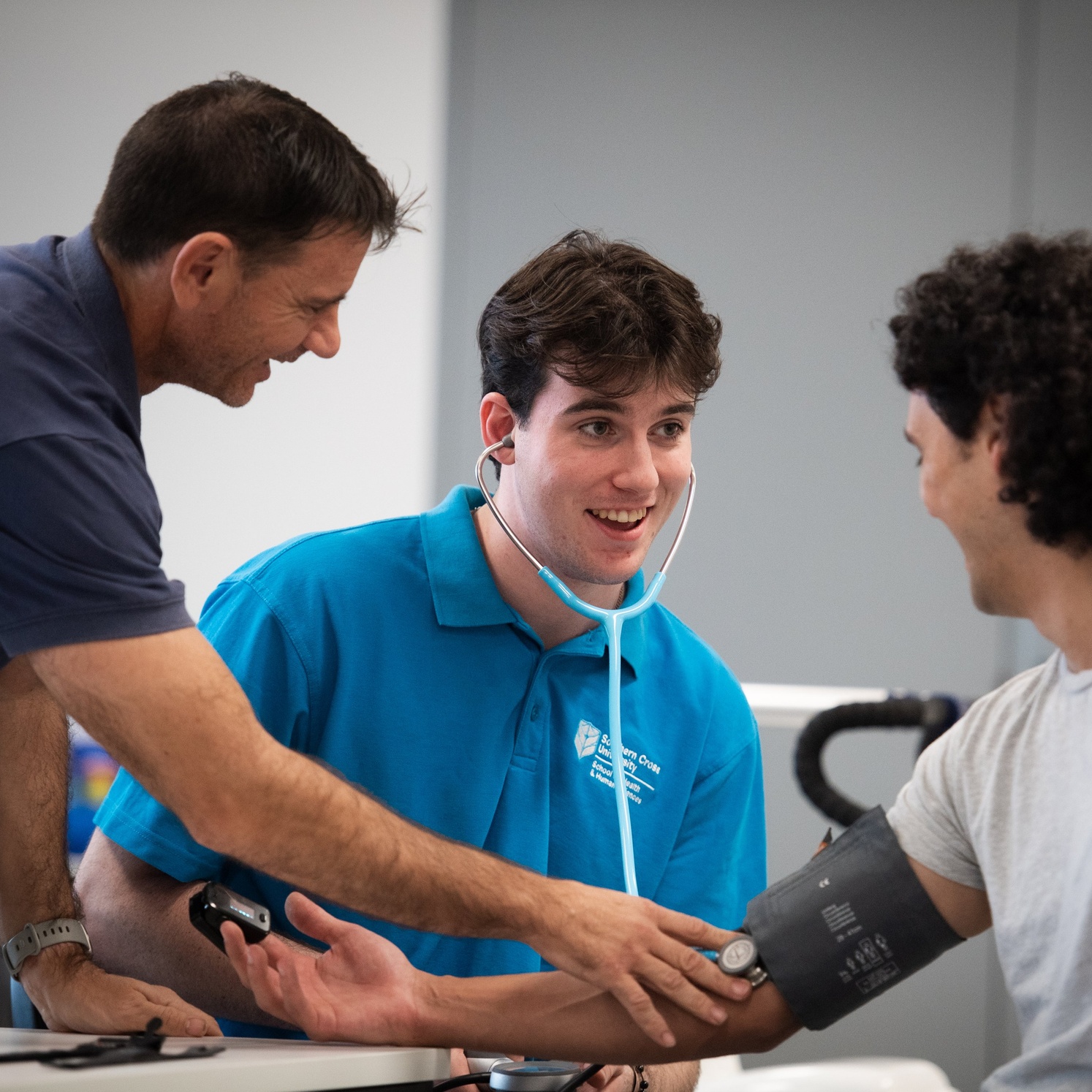 Student taking patients blood pressure