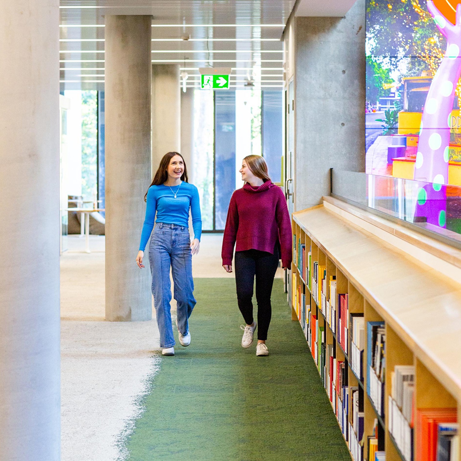 Two female students walking through Lismore Learning Centre