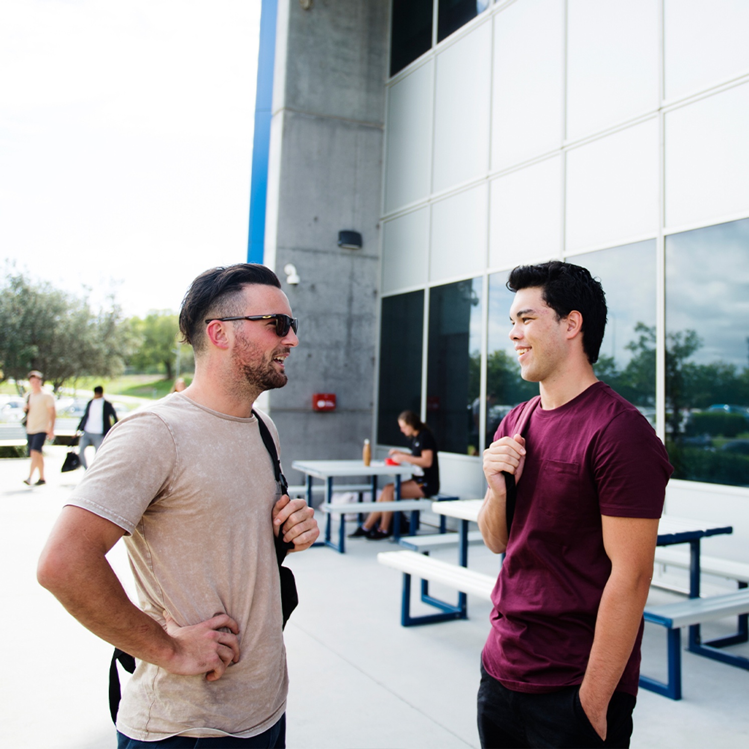 Two male students chatting outdoors at Gold Coast campus