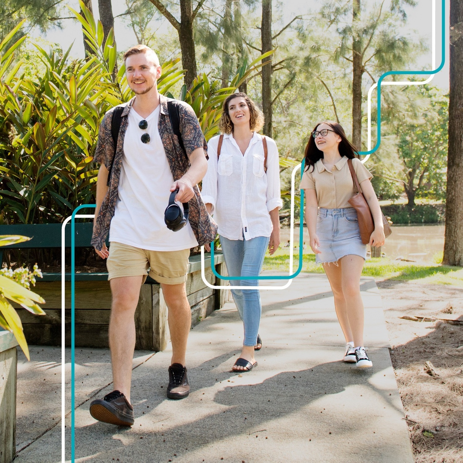 Three students walking through natural campus