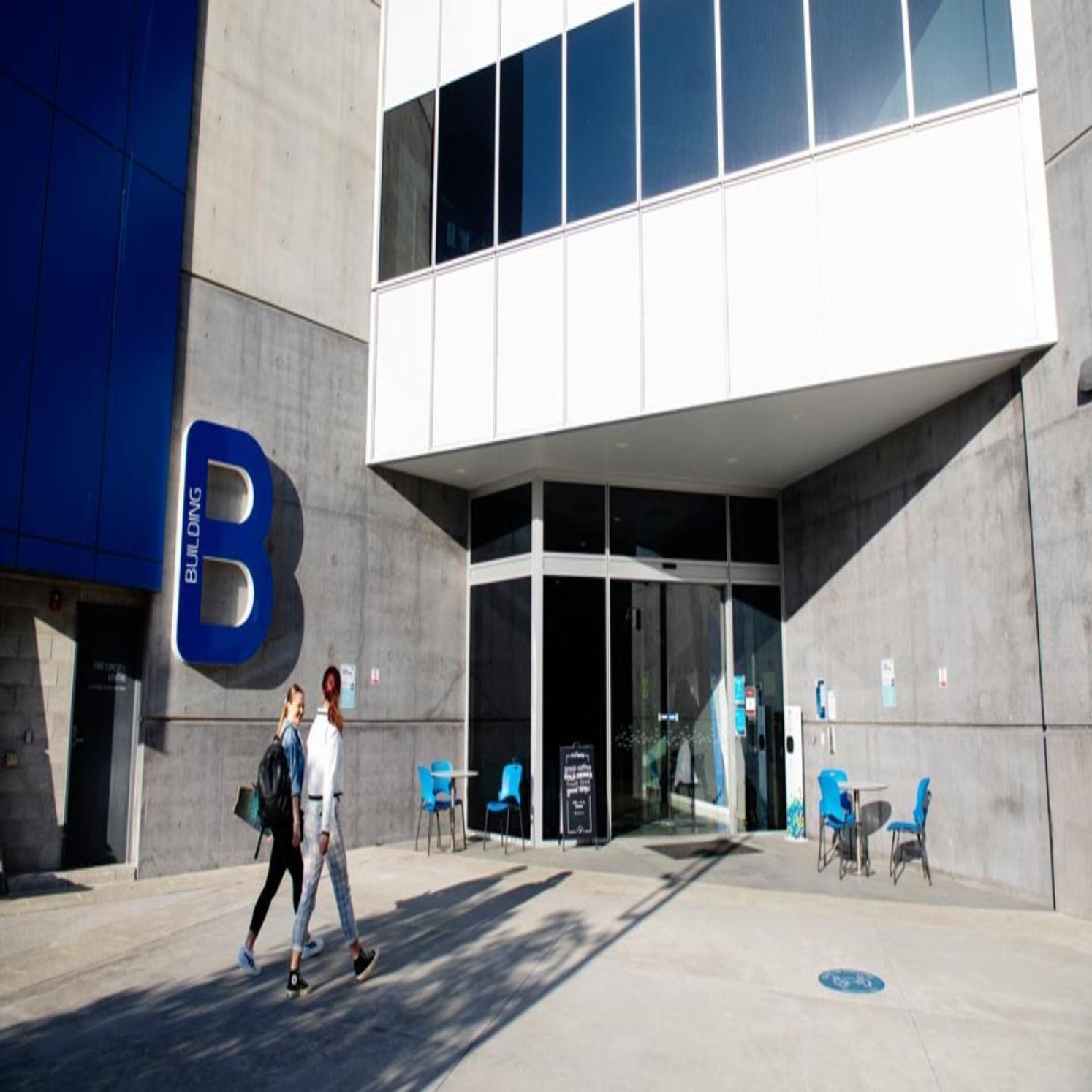 Two students walking into B Block at the Gold Coast campus