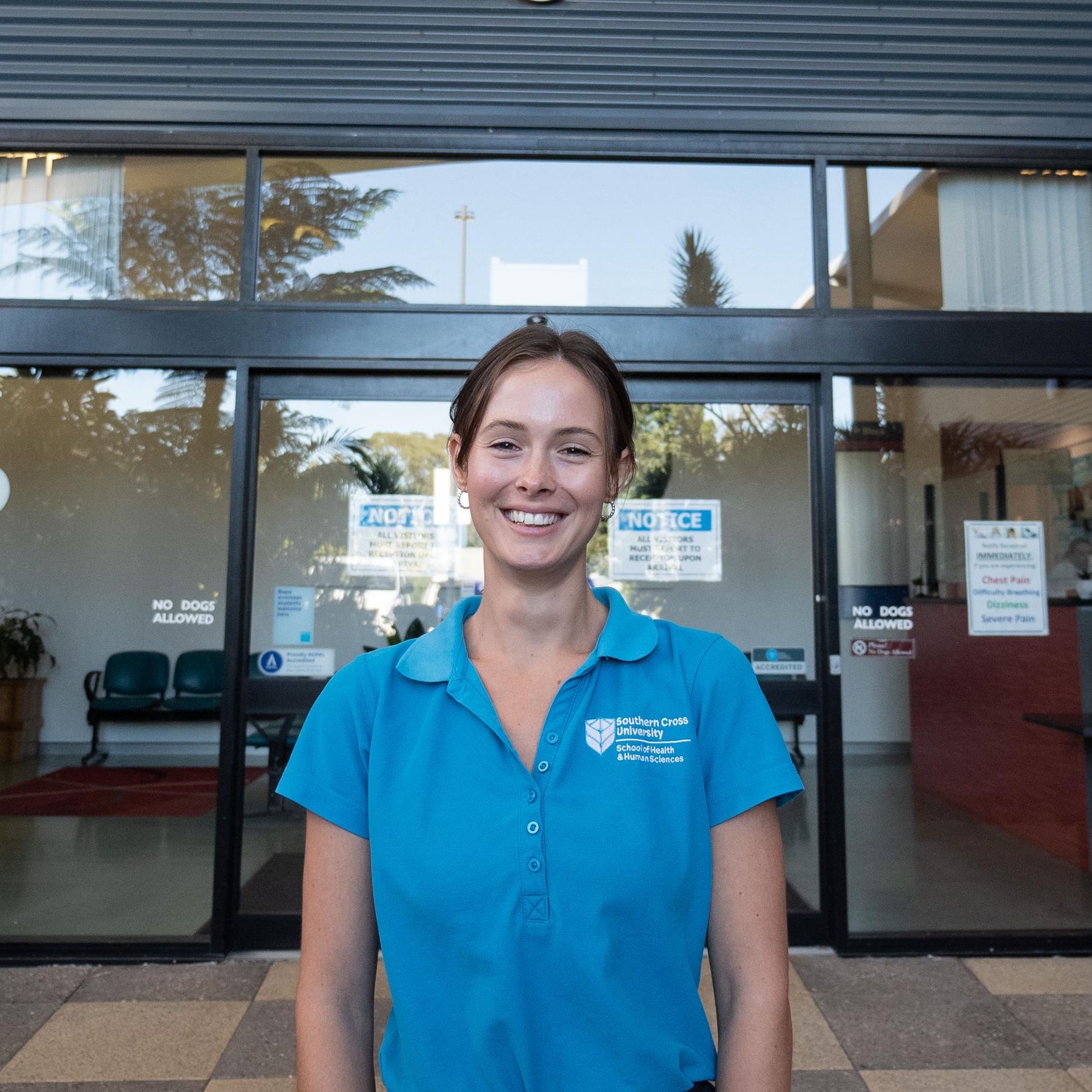 Osteo student smiling in front of the SCU Health Clinic