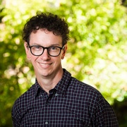 Man standing in front of a bush