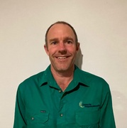 Smiling man head and shoulders with green shirt