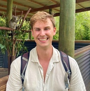 Portrait of Josh Guvat with koala in background