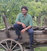 Adhwaith Das sitting on a cart in a field