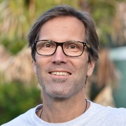Portrait of man in front of leafy backdrop