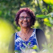 Darlene Rotumah stands among trees