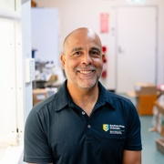 A man in a laboratory smiling at the camera
