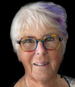 close up profile picture of lady with grey hear with colourful glasses