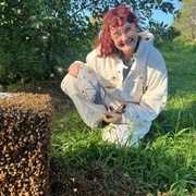Pip Davenport with bee hive in foreground