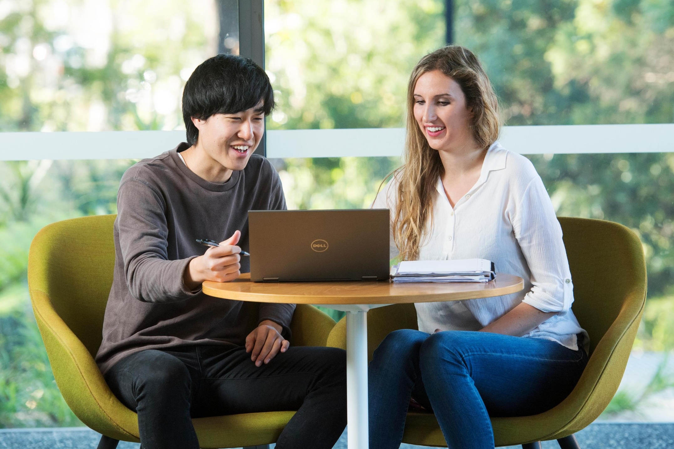 Male and female looking at open laptop