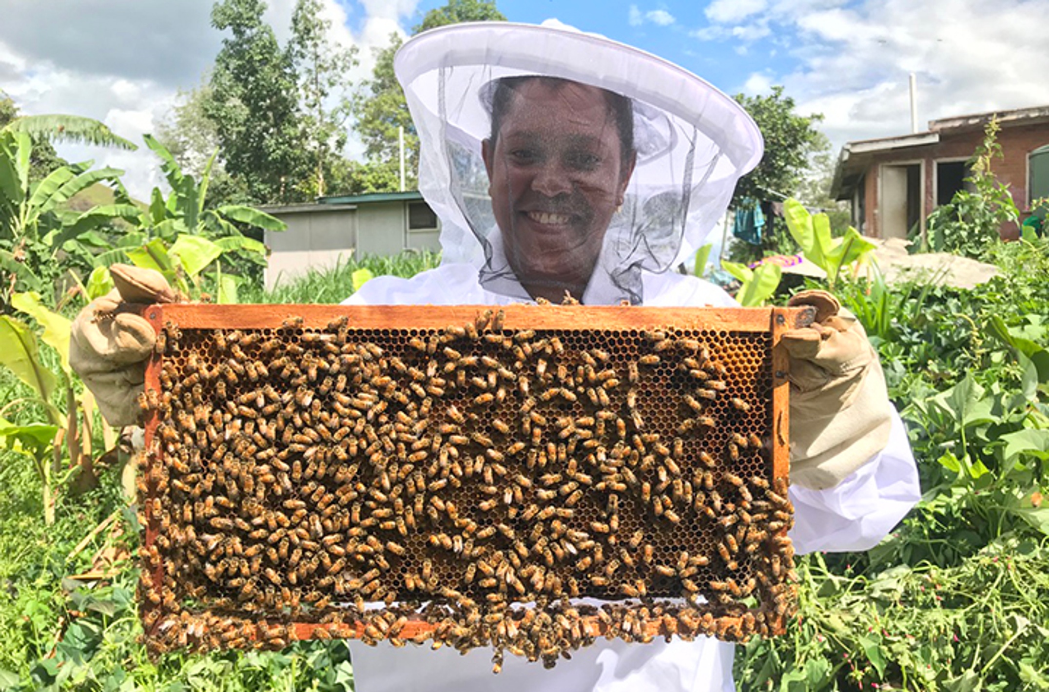 Villager with hive frame credit Cooper Schouten