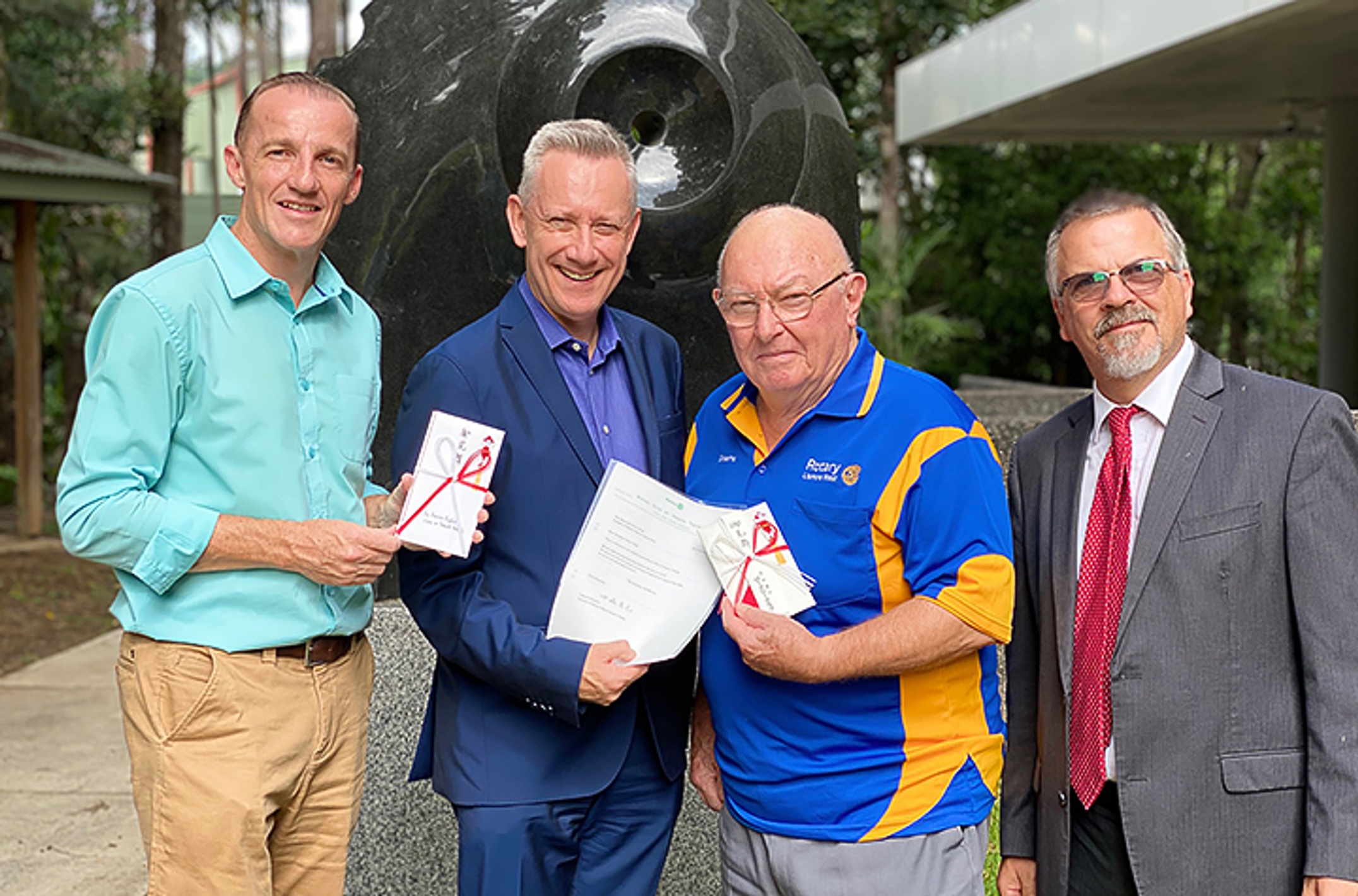 Lismore Mayor Isaac Smith, Vice Chancellor Professor Adam Shoemaker, Lismore West Rotary Secretary Graeme Hargreaves and Professor Peter Wilson accepting donations from the people of Yamato Takada to Lismore for bushfire relief.