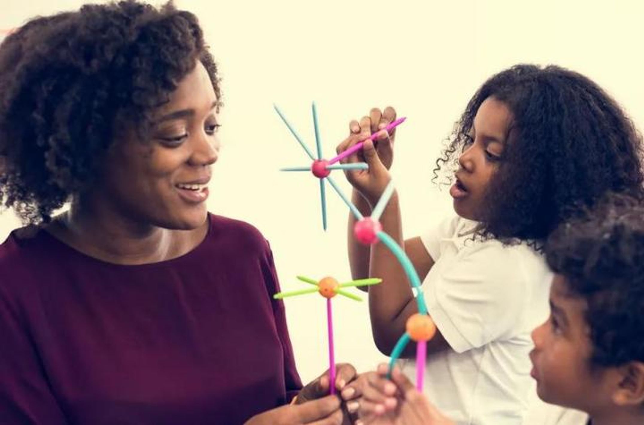 Adult African woman playing with three African children