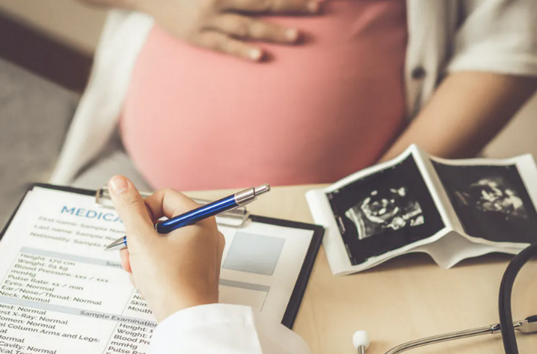 Pregnant woman with scans of womb