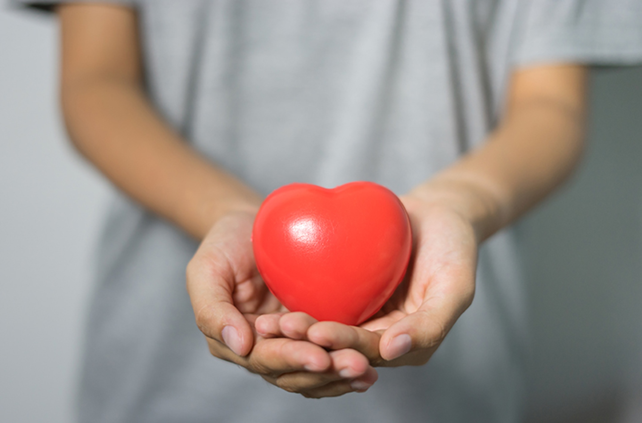 Cupped hands holding a heart