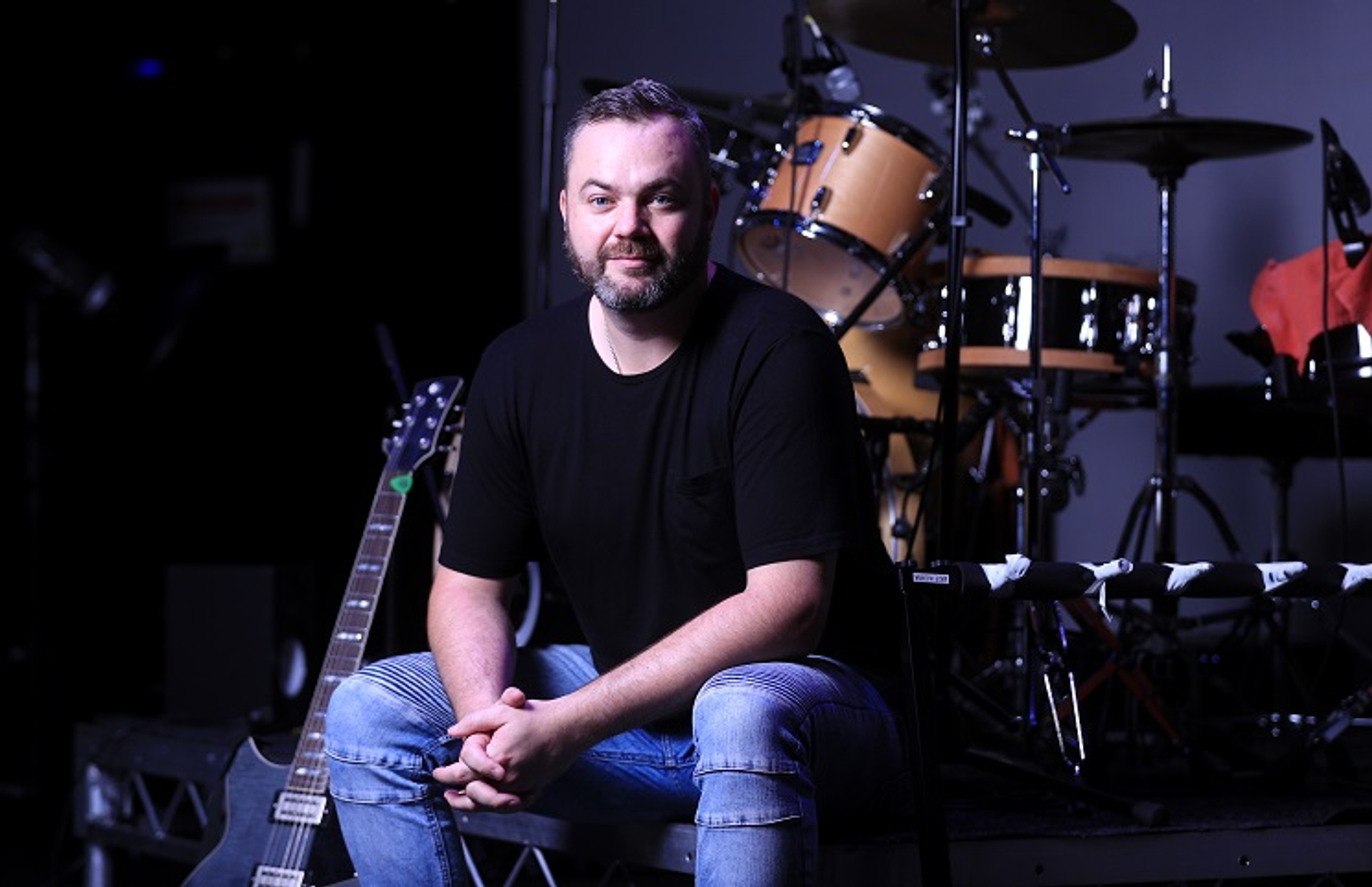 Man sitting in front of a drum kit