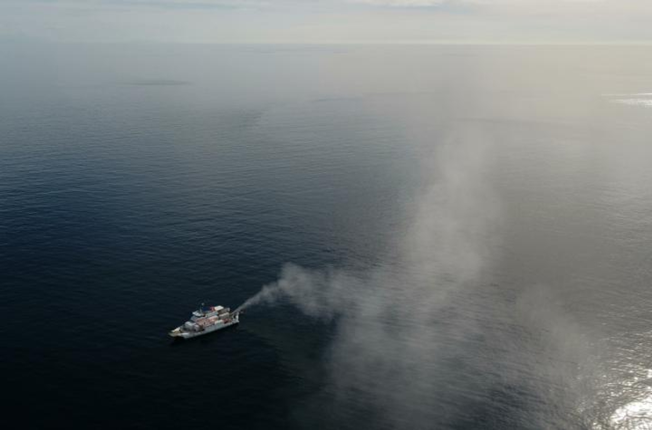Plume of seawater droplets from sprayer rises into the sky