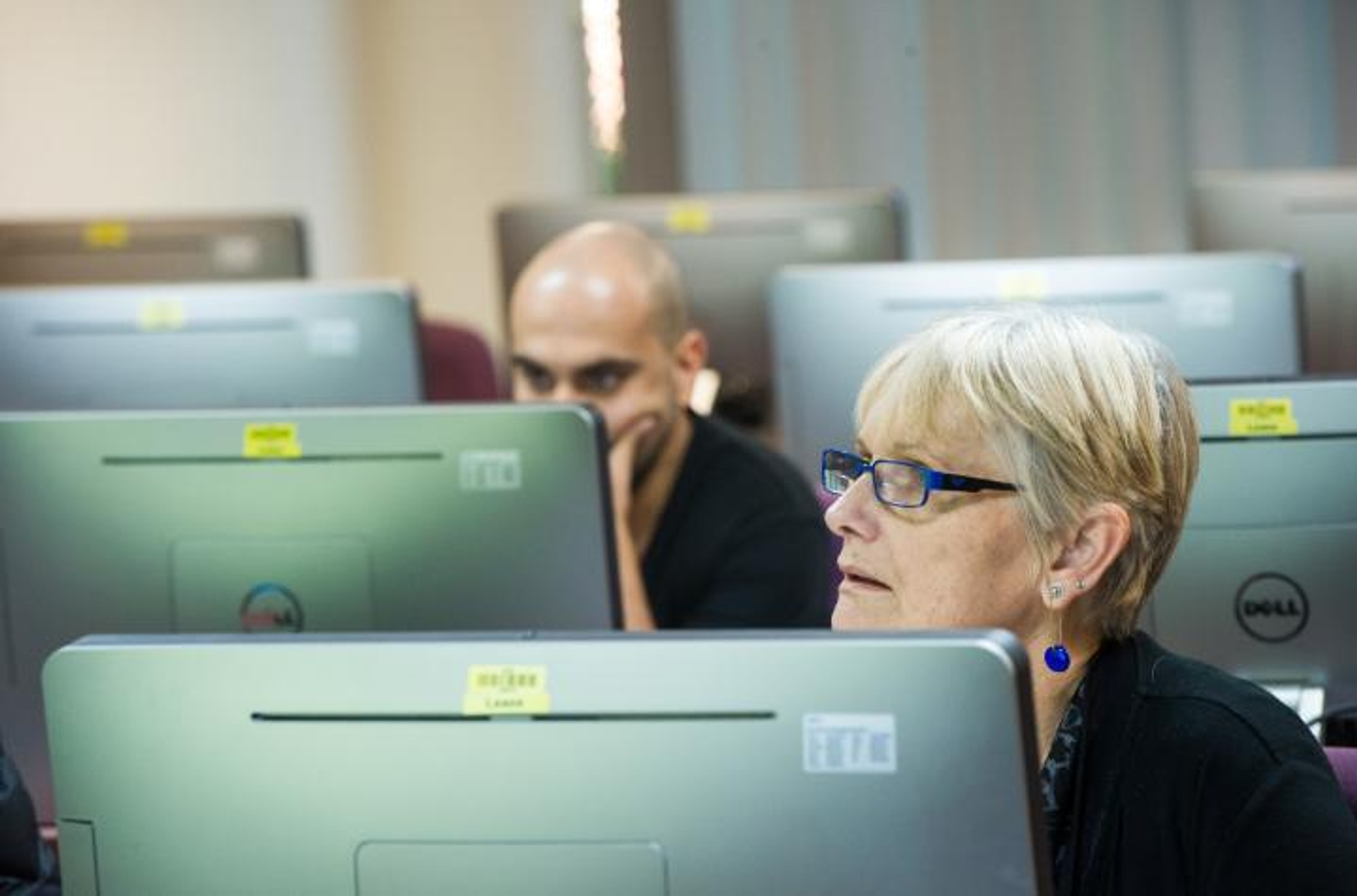 Two students sitting in front of computers