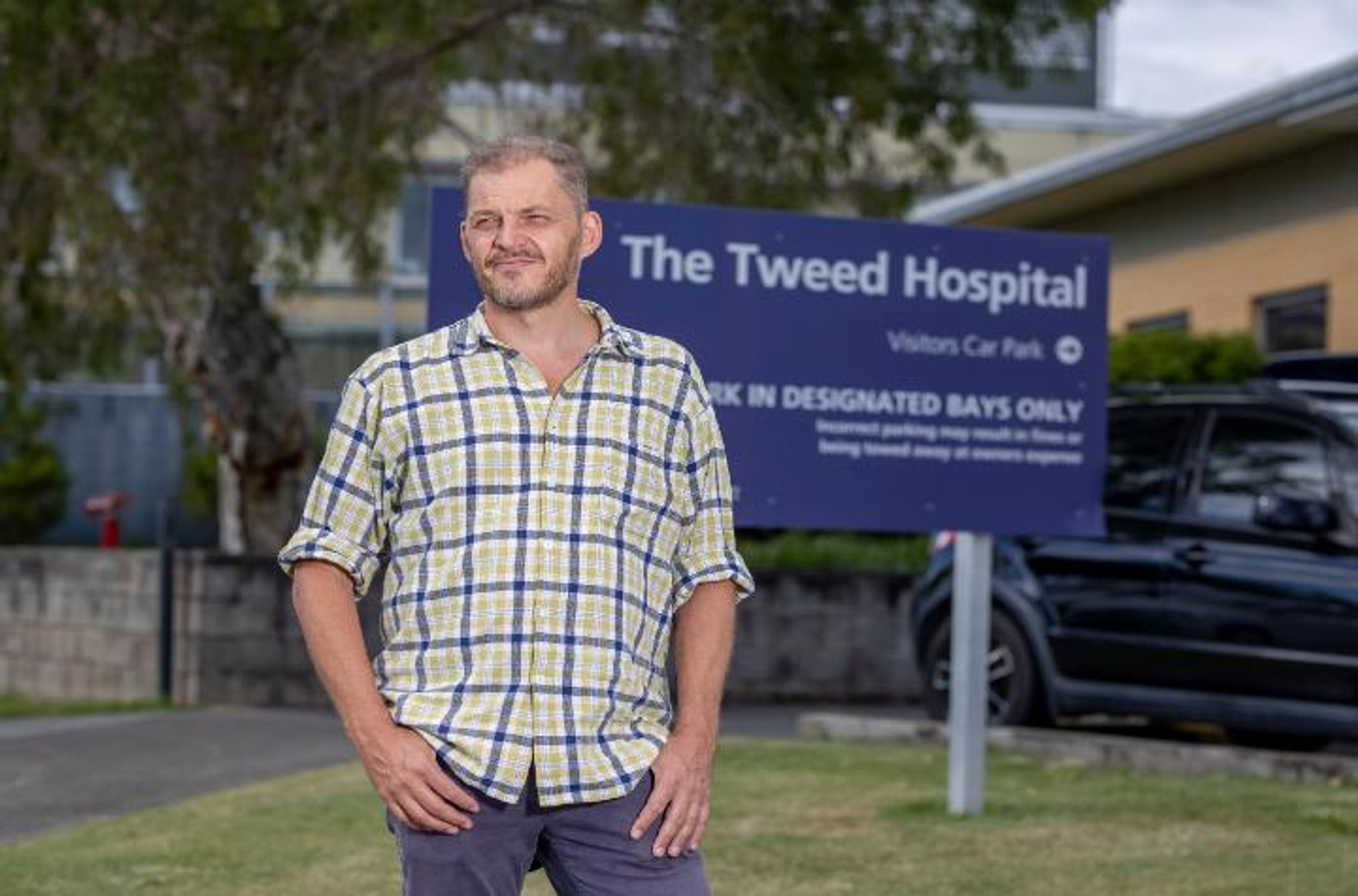 A man standing in front of a sign
