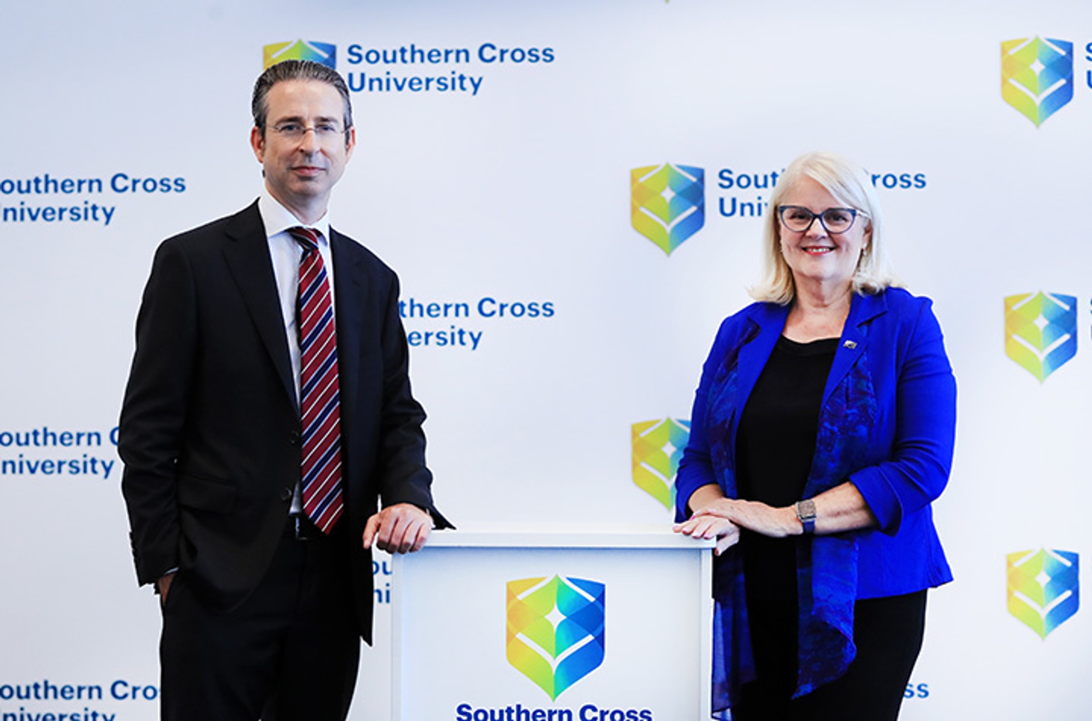 man on left and female on right with podium in middle