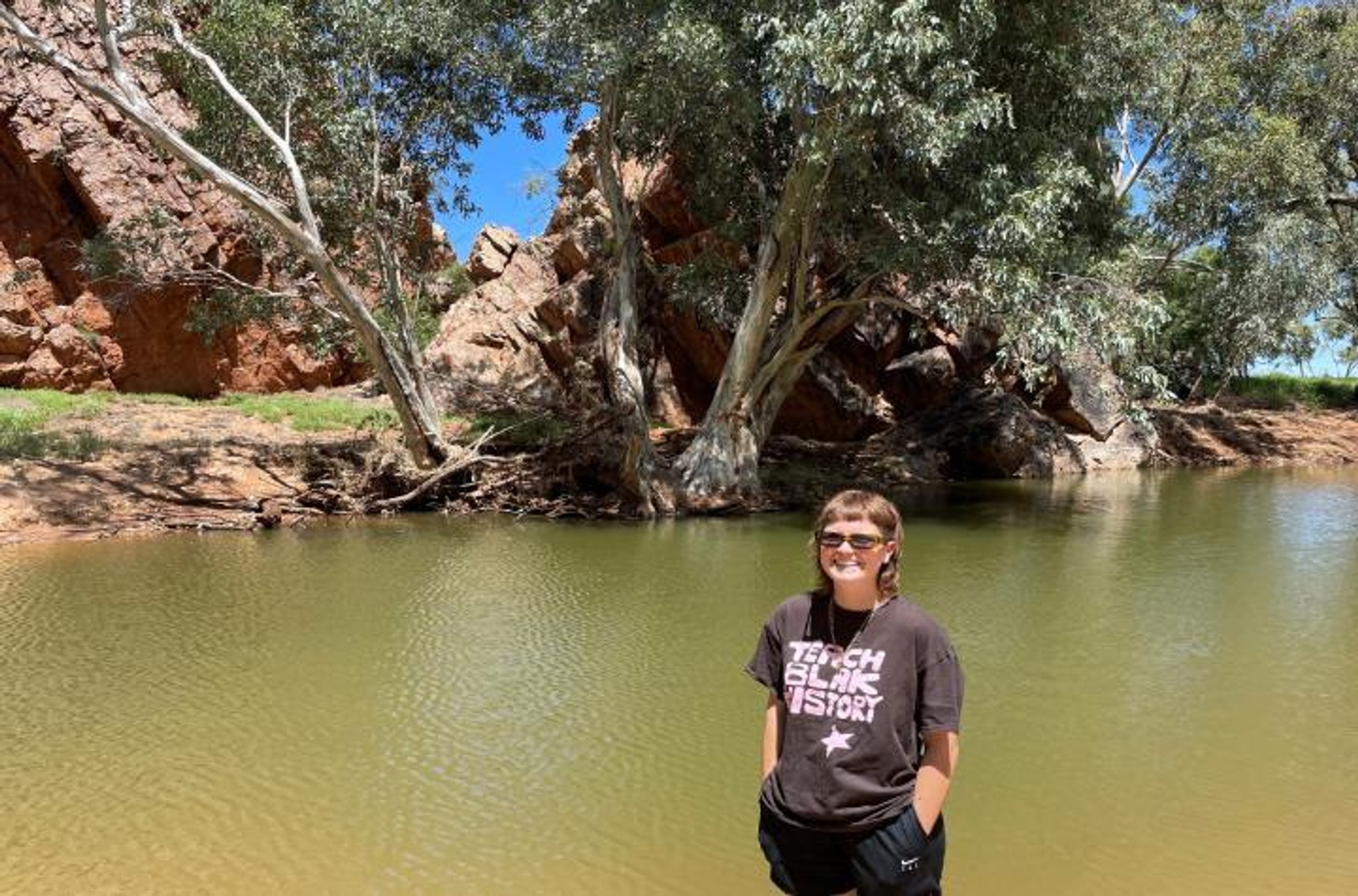 Woman standing by a billabong