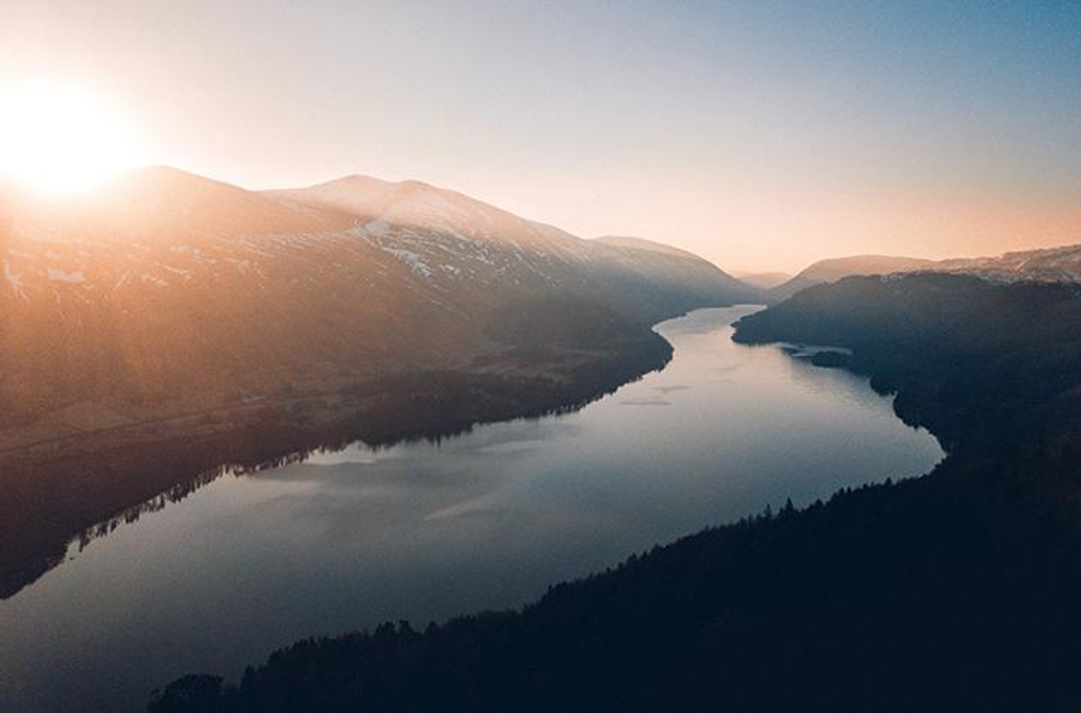 A river and mountain landscape at dawn