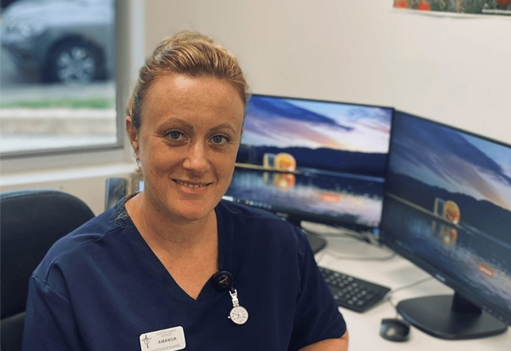Nurse Amanda Christie sitting at work desk