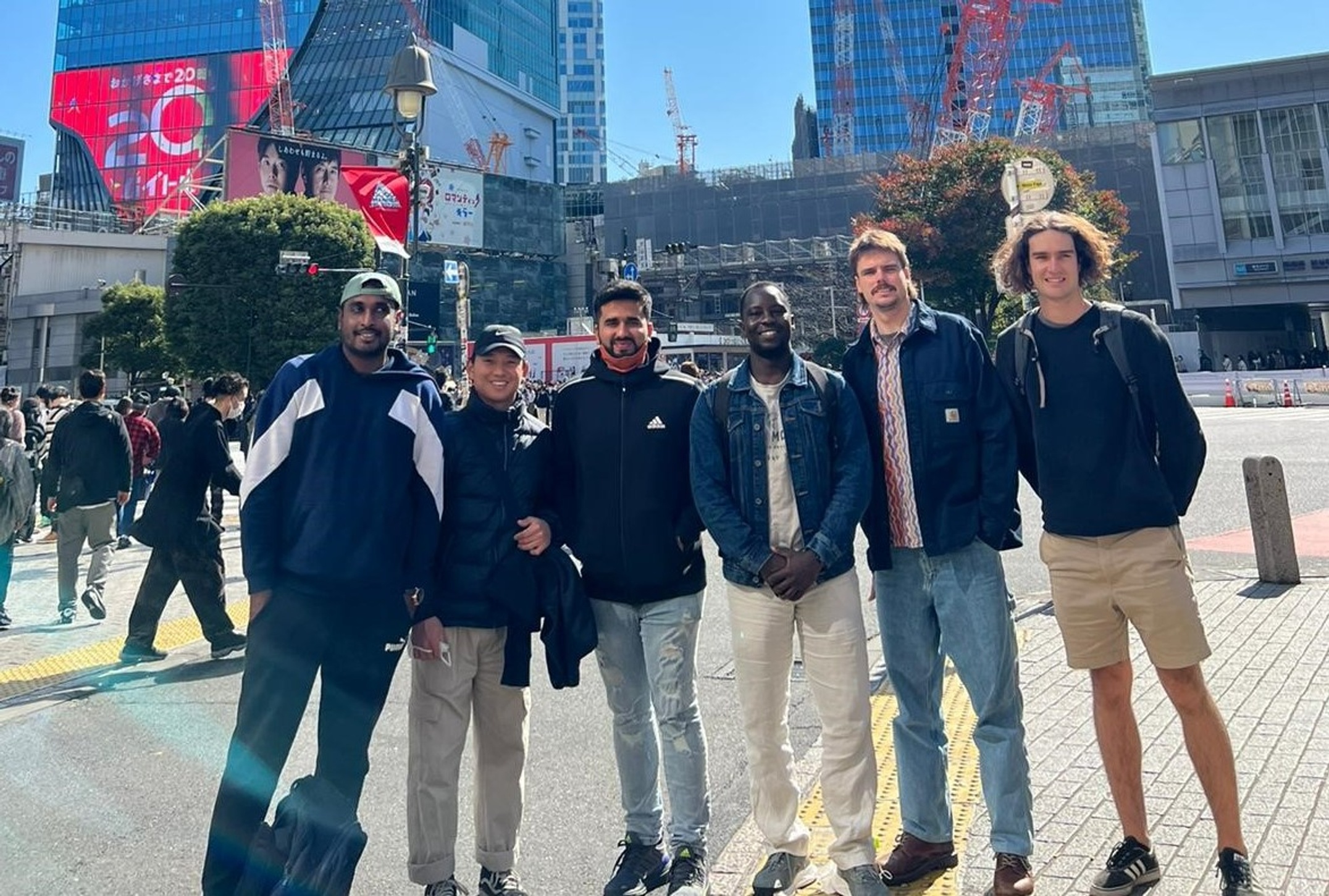 Group of students pose in front of Tokyo skyscrapers