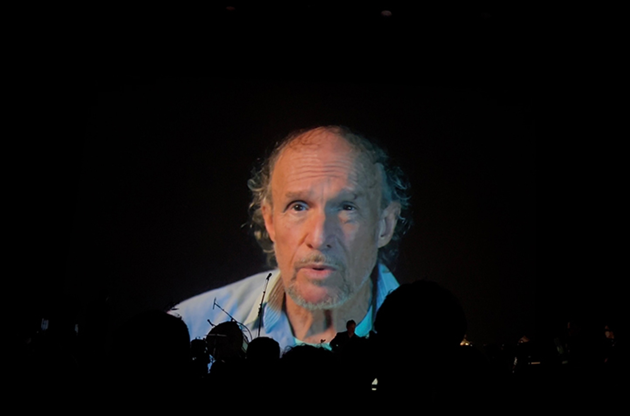 A man's face projected on a screen